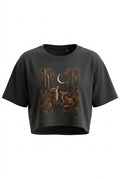 A dark charcoal gray cropped t-shirt featuring a detailed graphic print of desert cacti, coyotes, and a crescent moon in earthy brown and tan tones, displayed against a solid white background.